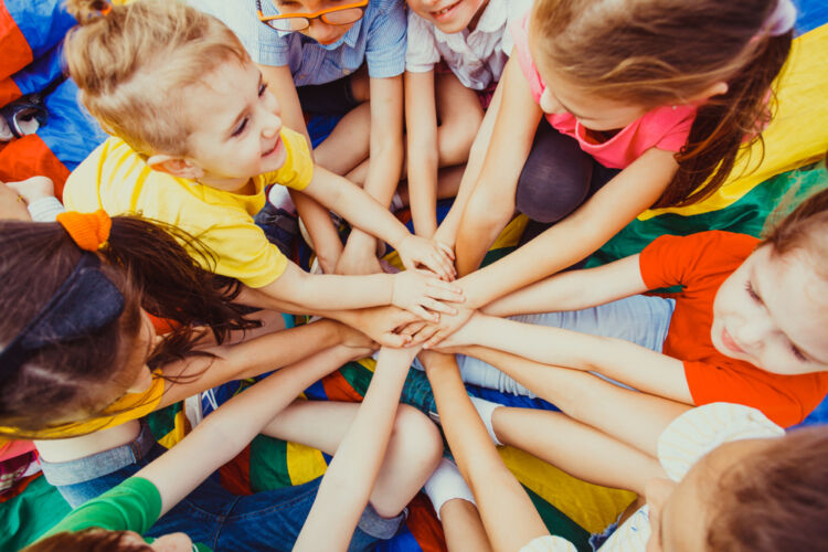 group,of,children,putting,their,hands,together